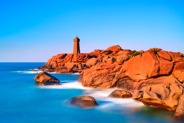 Ploumanach lighthouse sunset in pink granite coast, Brittany, Fr