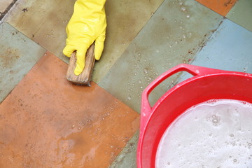 gloved hand cleaning of dirty filthy floor