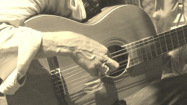 old-fashioned footage of a man playing guitar