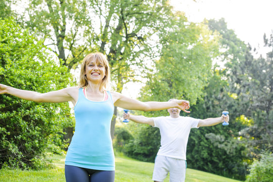 Personal trainer with client exercising outside