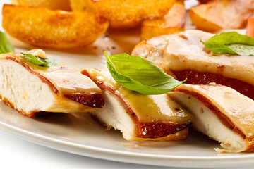 Grilled chicken breasts with cheese and baked potatoes