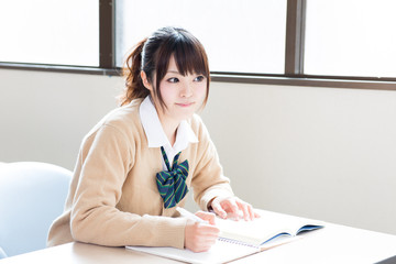 a young asian school girl studying