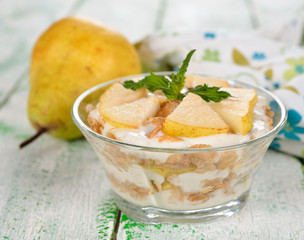 Dessert of muesli and yogurt with pear