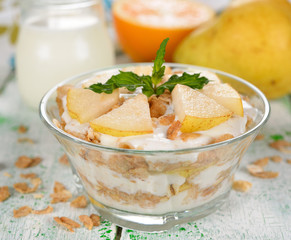 Dessert of muesli and yogurt with pear
