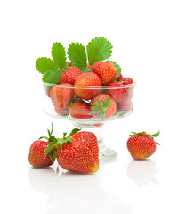 fresh strawberries in a glass bowl on a white background