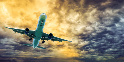 Airplane over dramatic sky