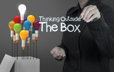 businesswoman hand draws word thinking outside the box