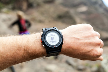 Runner looking at sport watch