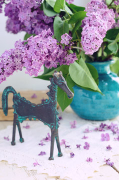 Decoration with horse statuette and lilac