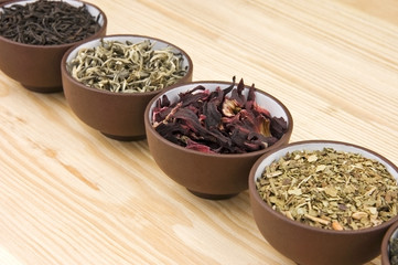 Assortment of dry tea in ceramic bowls