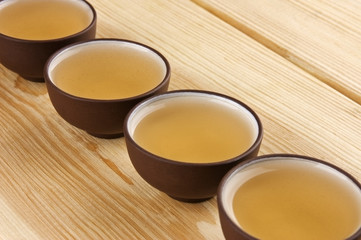 Fototapeta na wymiar Chinese traditional teacups with green tea close up