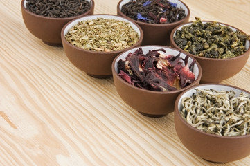 Assortment of dry tea in ceramic bowls