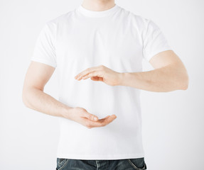 mans hands showing something