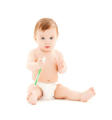 curious baby brushing teeth