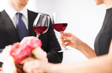 engaged couple with wine glasses