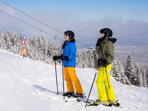 Teenage girl and boy skiing