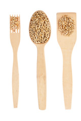 Wooden spoon, fork, paddle with barley