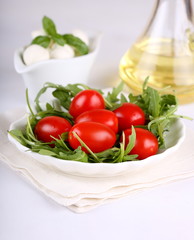 Ingredients for salad with arugula, tomatoes and mozzarella mini