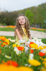 Fototapeta na wymiar Girl with beautiful orange and yellow poppies