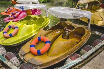 A row of bright paddle boats
