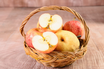 Apples in basket on a wood background