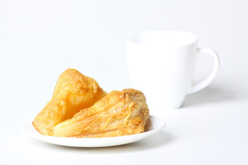 Breakfast with coffee and croissants on white background