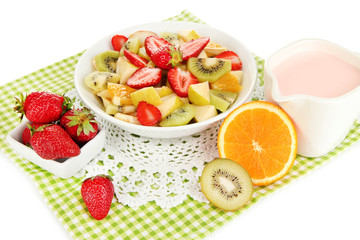 Useful fruit salad of fresh fruits and berries in bowl isolated