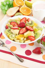 Useful fruit salad of fresh fruits and berries in bowl