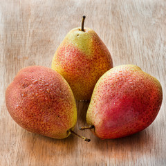 Fresh red pears over wooden background