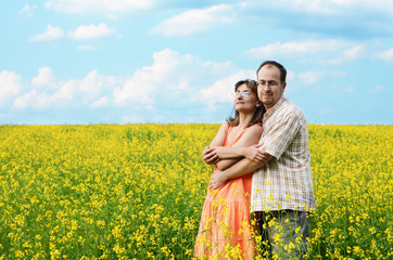 Happy man and woman in yellow meadow