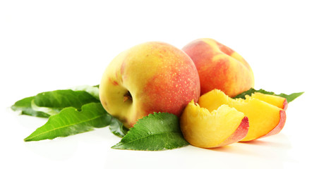Ripe sweet peaches with leaves, isolated on white