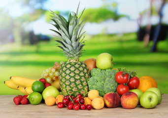 Assortment of fresh fruits and vegetables on natural background