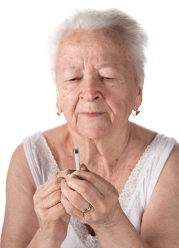Old  woman preparing syringe for making insulin injection