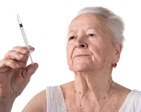Old  woman preparing syringe for making insulin injection