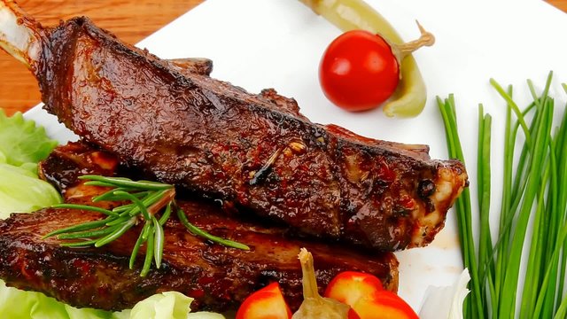 served ribs with cutlery on wooden table 1920x1080 intro motion 