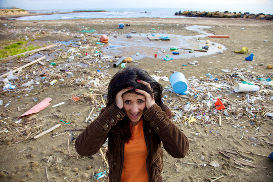 Woman shouting in front of ecologic disaster dirty beach
