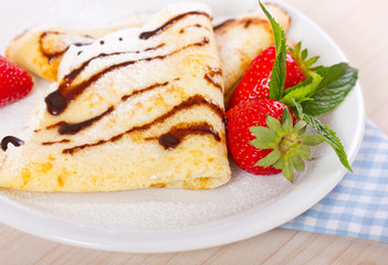 Crepes with chocolate syrup and strawberry