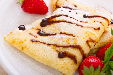 Crepes with chocolate syrup and strawberry