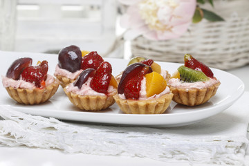 Colorful cupcakes - party dessert. White table setting.