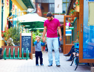 upset baby and father on the city street