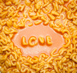 love spelt with spaghetti letters on a plate