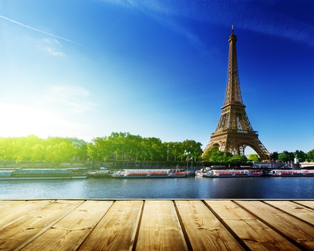 background with wooden deck table and  Eiffel tower in Paris