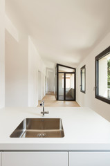 interior new house, modern white kitchen, view sink of steel