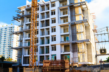Apartments construction site with yellow crane