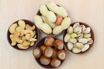 Mixed nuts with and without shell in wooden bowls