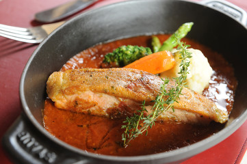 Frying pan with salmon steaks