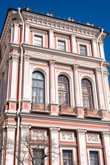 Balcony of the old house with three big windows and columns