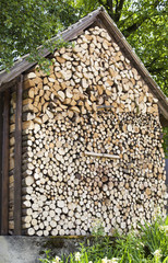 Accurately combined fire wood at a wooden house wall