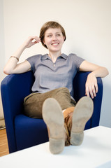 Obraz premium young beautiful hipster woman sitting in the armchair
