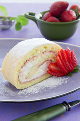 Biscuit roll with strawberry jam, and strawberries.
